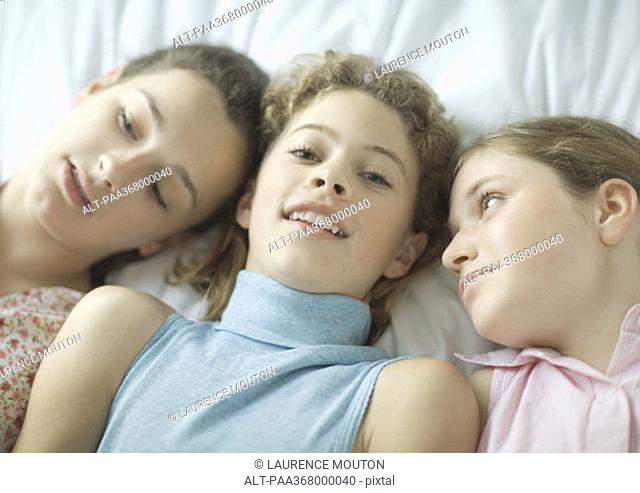 Teenage girls lying down together