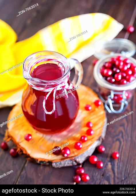 fresh cranberry in bowl and juice in jug on a table