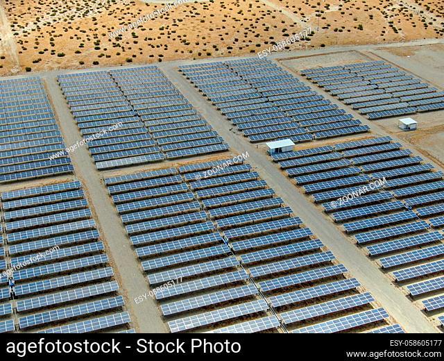 Aerial view of Genuine Energy Farm in the Hot Arid Desert of Palm Springs, California. Solar Panels farm to Harness the Power of Nature to generate free green...