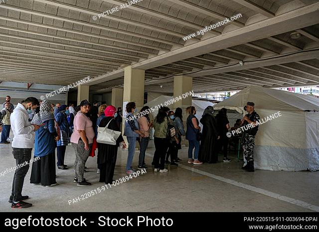 15 May 2022, Lebanon, Beirut: Lebanese voters wait in line to cast their votes outside a tent donated by the Lebanese Red Cross inside a polling station in...
