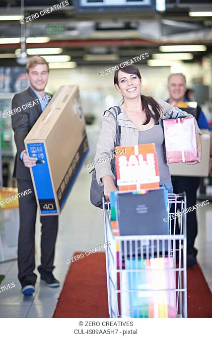 Woman leaving showroom with abundance of purchases