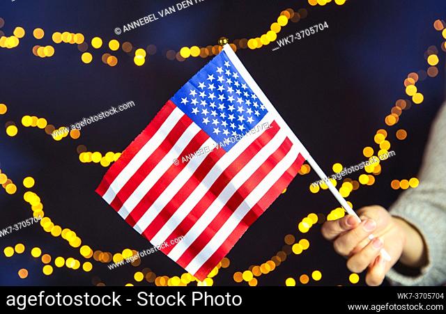 USA flag, red white and blue with sparkling yellow bokeh background, Copy space, space for text. colorful design American concept dark with lights