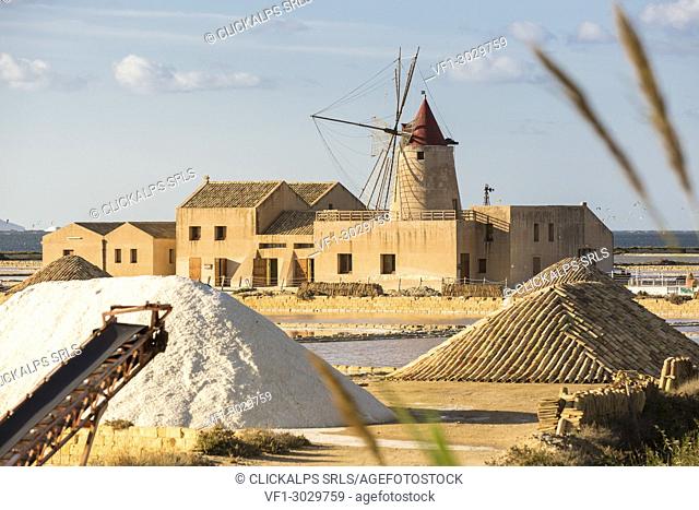 Pyramids of salt in front of Infersa windmill, on the coast connecting Marsala to Trapani, Trapani province, Sicily, Italy