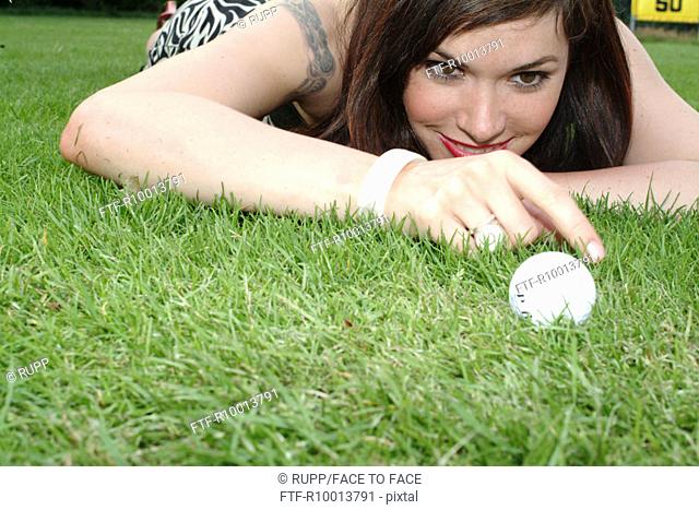 Woman playing with a golf ball