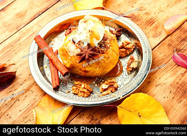 Baked apples stuffed with oatmeal and nuts.Baked apples on wooden table