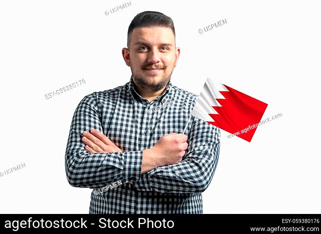 White guy holding a flag of Bahrain smiling confident with crossed arms isolated on a white background