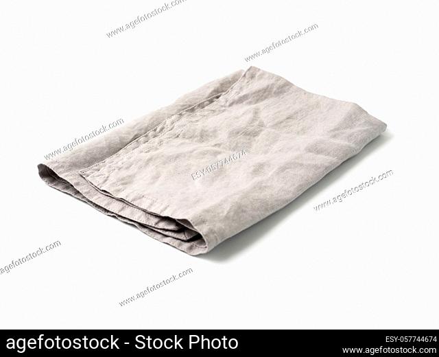 Side view on folded gray linen napkin isolated on white background. light gray linen napkin. Isolated on white with clipping path