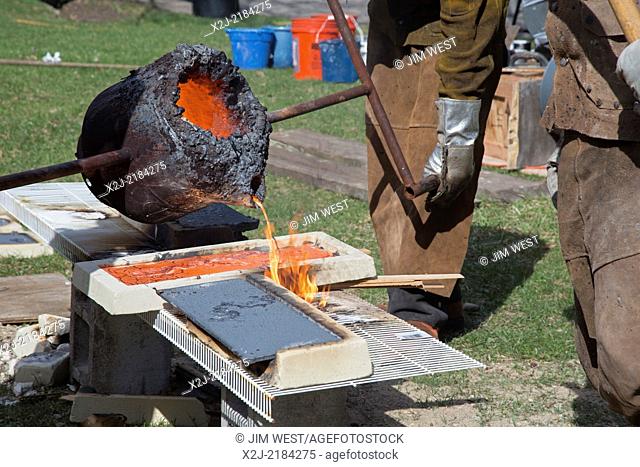 Detroit, Michigan - Members of the Carbon Arts nonprofit educational foundation melt iron and pour it into molds at the Palmer Park Art Fair