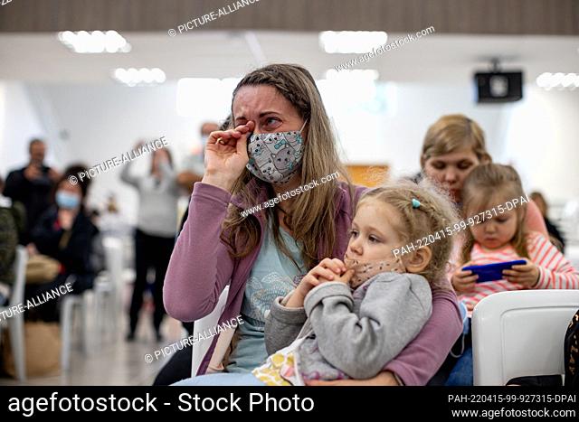 dpatop - 14 April 2022, Brazil, Mandirituba: Tetiana from Ukraine cries with her daughter in her arms during a welcoming ceremony after her arrival with a group...