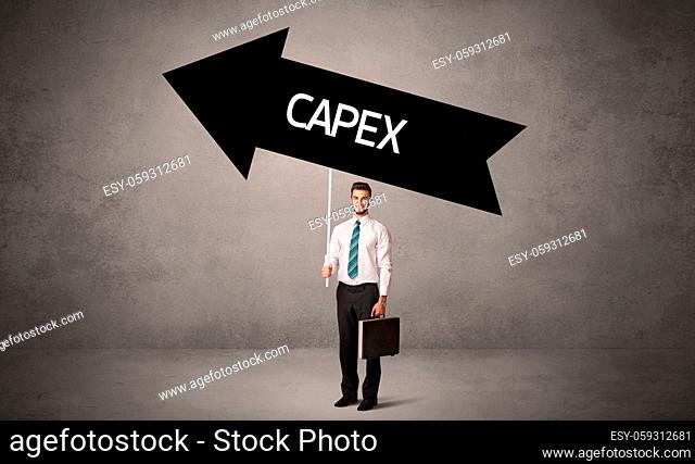 Young business person in casual holding road sign with CAPEX inscription, business direction concept