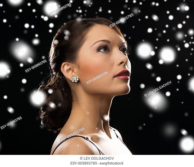 luxury, vip, nightlife, party, christmas, x-mas, new year's eve concept - beautiful woman in evening dress wearing diamond earrings