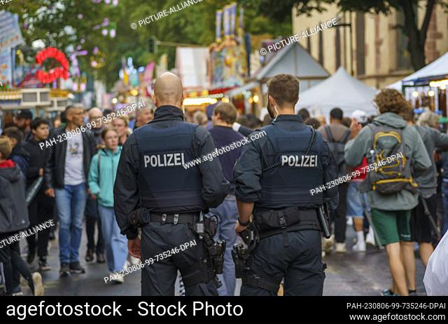 06 August 2023, Hesse, Frankfurt/Main: A police patrol walks the festival route. The Mainfest (04.08.-07.08.23) is one of the oldest public festivals in...