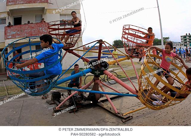 A self-made carousel is great fun not only for children during carnival (Carnaval 2014) at the Malecon in Baracoa, Cuba, 12 April 2014