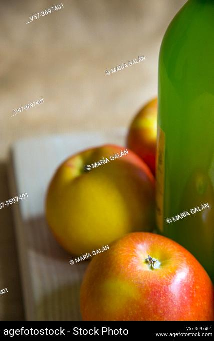 Bottle of cider with apples, close view. Asturias, Spain