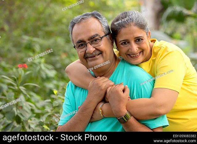 PORTRAIT OF A HAPPY HUSBAND AND WIFE POSING TOGETHER