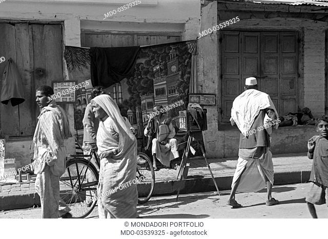 People walking in a street of Varanasi. Varanasi, 1965
