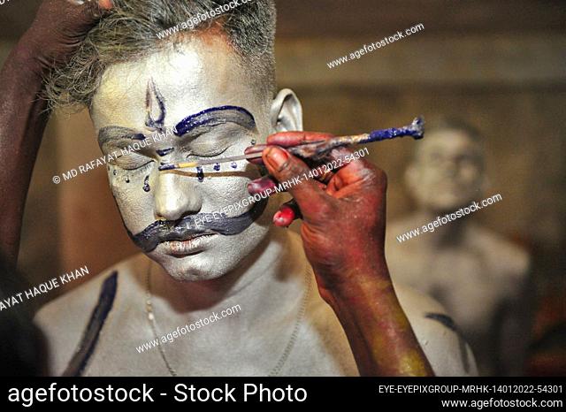KULAWRA, BANGLADESH - JANUARY 14, 2022: A Devotee taking makeup for performing during Charak Puja Festival during Poush Shonkhanti of Bangla Calendar year