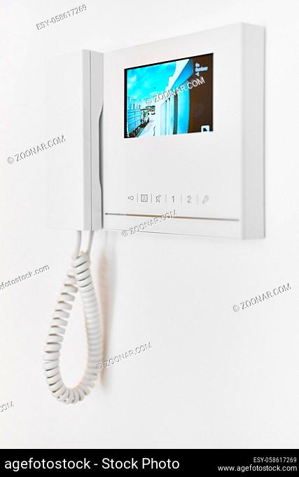 Concept of smart modern luxury wealthy home. On white wall video intercom with street view talkback or doorphone voice communications system close up, no people