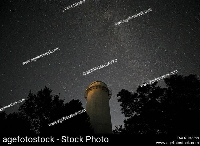 RUSSIA, REPUBLIC OF CRIMEA - AUGUST 12, 2023: A view of a falling star of the Perseid meteor shower in the sky over the Crimean Astrophysical Observatory in the...