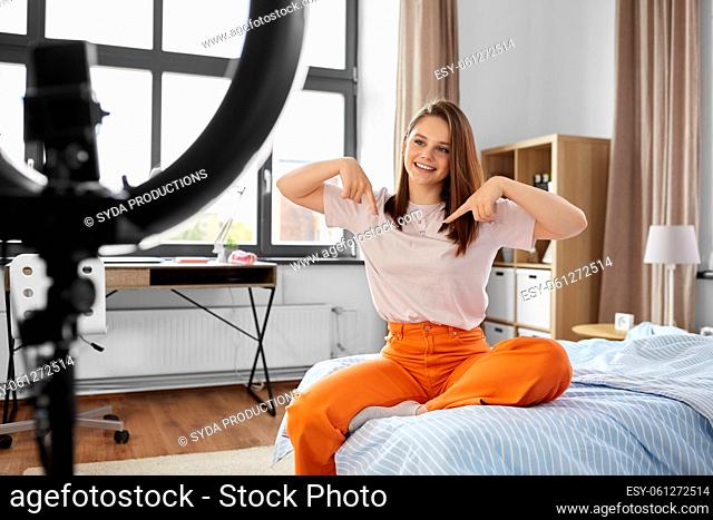 girl blogger with ring light streaming at home
