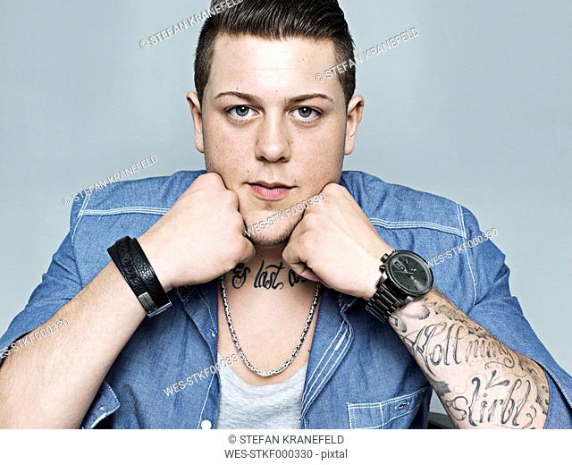 Portrait of young man with tattoo, close up