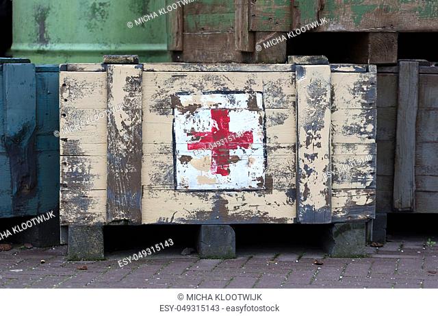 EMMEN, THE NETHERLANDS, Jan 4, 2019: A stenciled logo of the Red Cross on an old first in a zoo in Emmen, the Netherlands on Januari 4, 2019