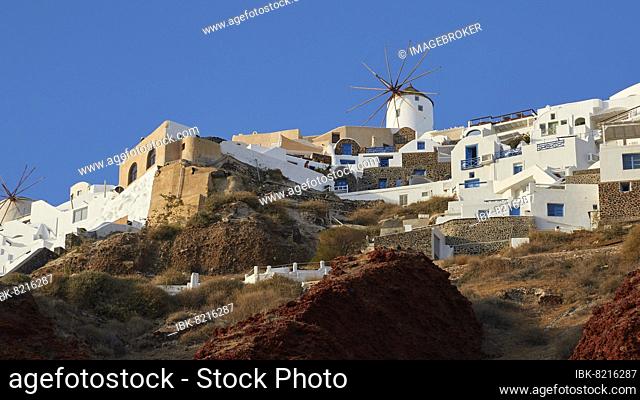 Afternoon light, blue cloudless sky, houses on cliff, windmill, Oia, Santorini Island, Cyclades, Greece, Europe