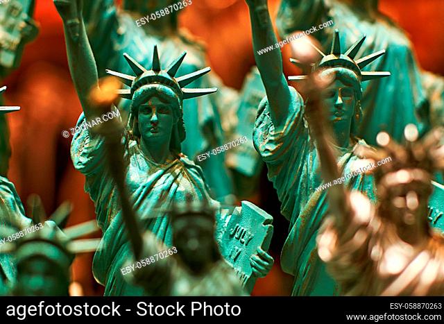 Row with generic Statue of Liberty statues sold as souvenirs in a New York shop - selective focus