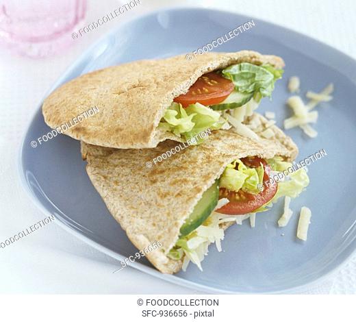 Wholemeal pita pockets filled with salad and grated cheese