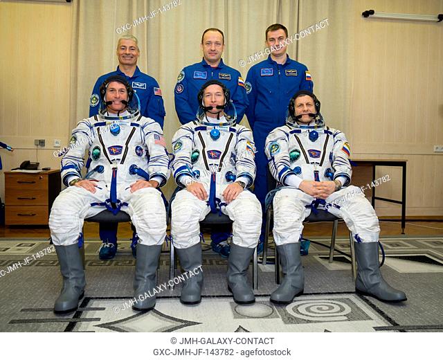 Expedition 49 prime crew members, seated in their Sokol suits, Shane Kimbrough of NASA, left, Soyuz commander Sergey Ryzhikov, center