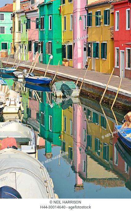 Canal lined with colorful houses in the middle of the pretty little island of Burano in the Venice lagoon