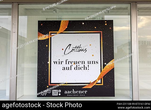 08 November 2023, Brandenburg, Cottbus: An image poster hangs in a shop window of the fashion store ""Aachener"", which has not yet opened