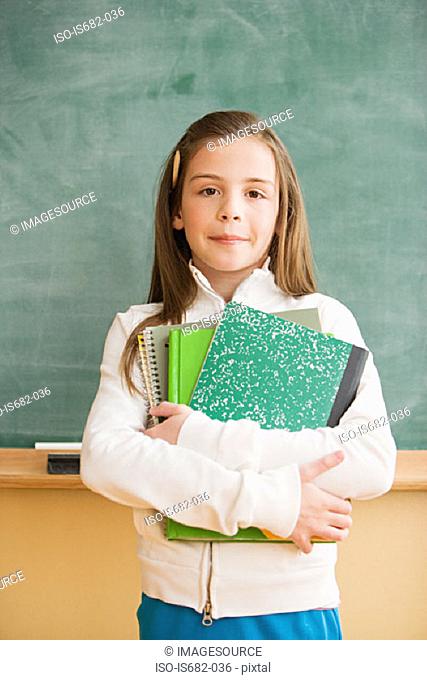 Schoolgirl holding textbooks