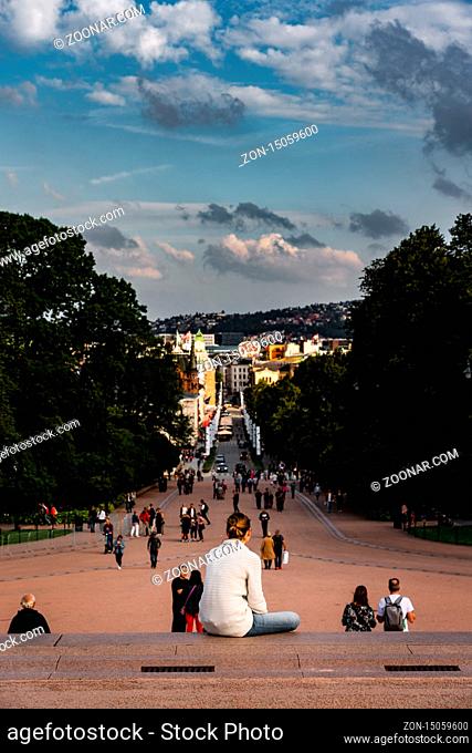Editorial 08.31.2019 Oslo Norway Girl sitting on the steeps to the King Caste and looking down at the long Karl Johans street