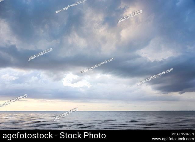 Europe, Germany, Lower Saxony, Otterndorf. Approaching storm over the Outer Elbe, on the right in the background the coast of Schleswig-Holstein