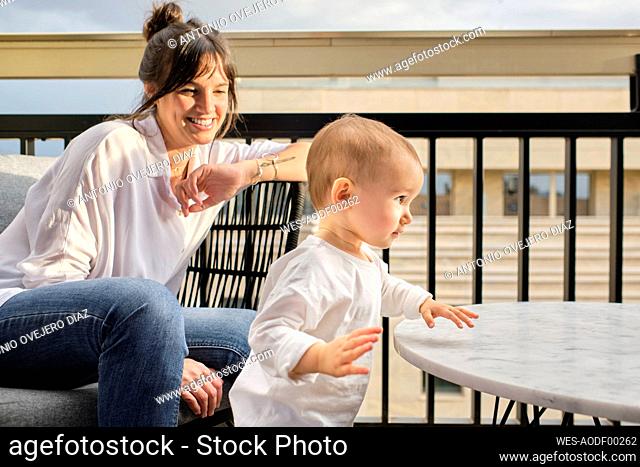 Mother spending time with toddler on balcony