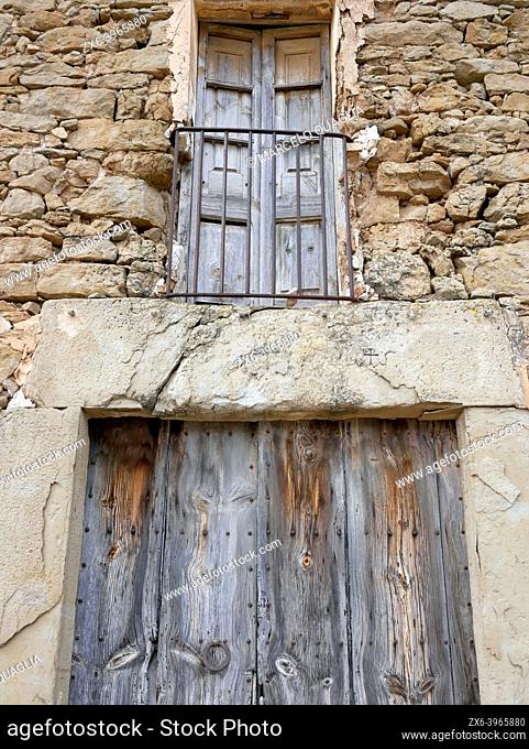Door and balcony of an old stone house. Santa EulÃ lia de Puig Oriol Village. Lluçanès region, Barcelona province, Catalonia, Spain