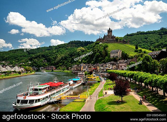 COCHEM, GERMANY - JUNE 22, 2020: Panoramic image of Cochem with old castle and river cruise ships on June 22, 2020 in Germany