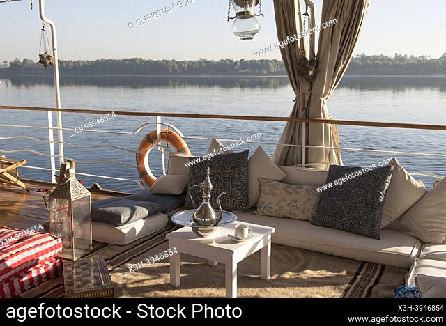 lounge on the deck of a Dahabeah, passenger river boat of the Lazuli fleet, sailing on the Nile river, Egypt, northeast Africa