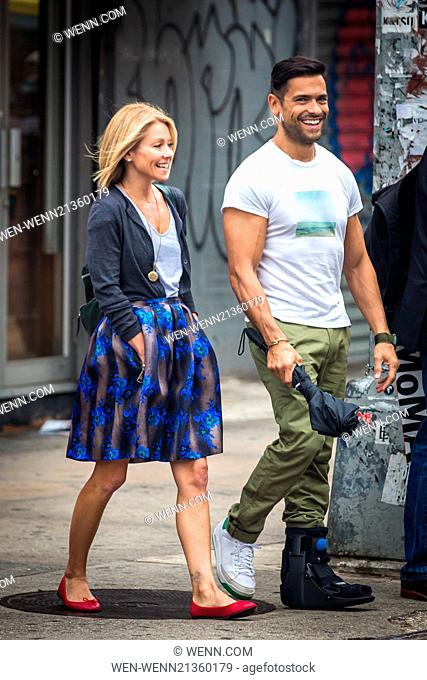 Kelly Ripa and Mark Consuelos were all smiles in spite of wet weather as they were spotted strolling through SoHo Featuring: Kelly Ripa