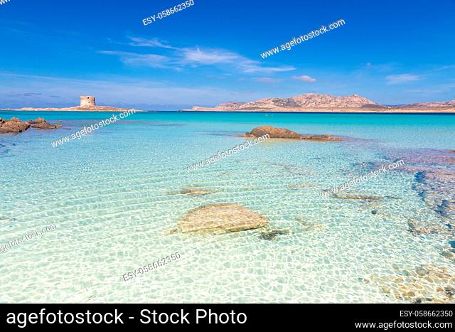 Stone tower on a beautiful turquoise blue mediterranean Pelosa beach near Stintino, Sardinia, Italy