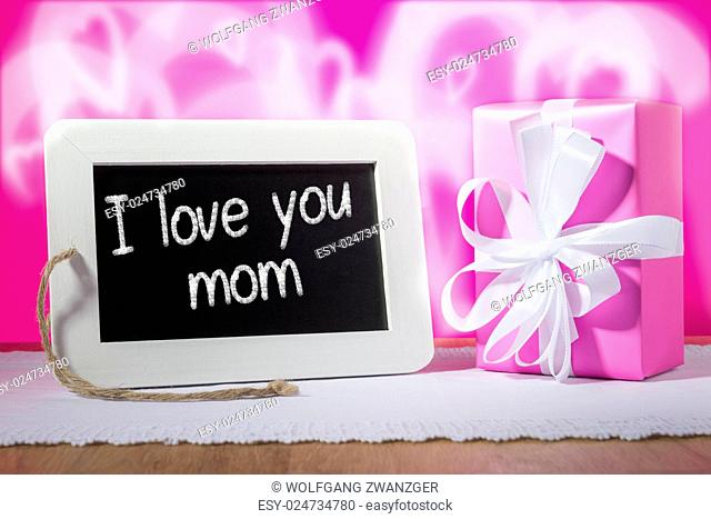 Image of a slate blackboard with chalk message I love you mom and pink gift