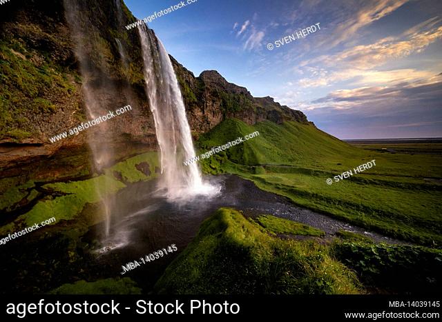 the enormous seljalandsfoss waterfall in the south of iceland