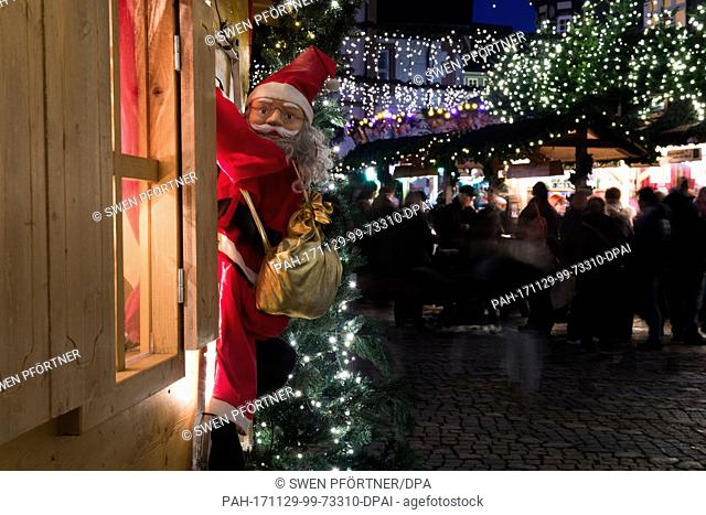A Santa Claus figure hangs on the window of a stand at the Christmas market in Goslar, Germany, 29 November 2017. The Christmas market in Goslar is open from 29...