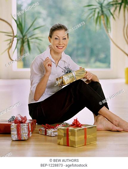 Woman unwraping gifts