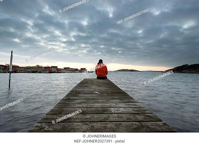 Man on jetty looking at view