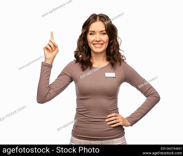 happy female shop assistant pointing finger up