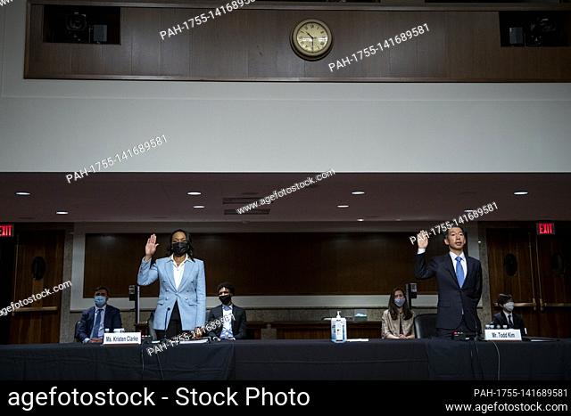 Kristen Clarke, left, and Todd Sunhwae Kim, right, are sworn-in as they appear before a Senate Committee on the Judiciary hearing for her nomination to be...