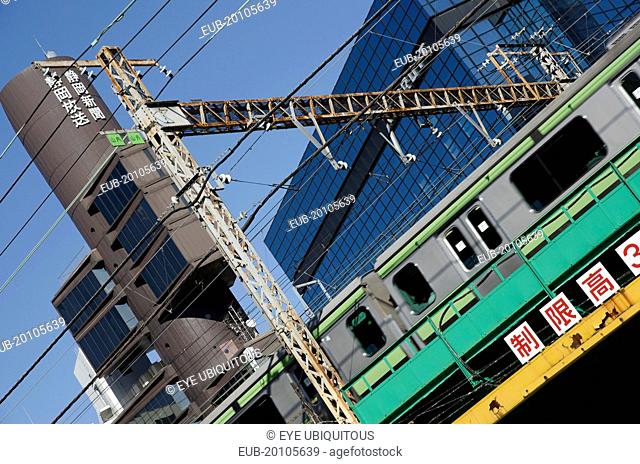 Shinbashi a JR Yamanote line train crosses overhead