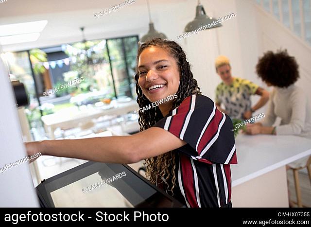 Portrait happy young woman cooking kitchen
